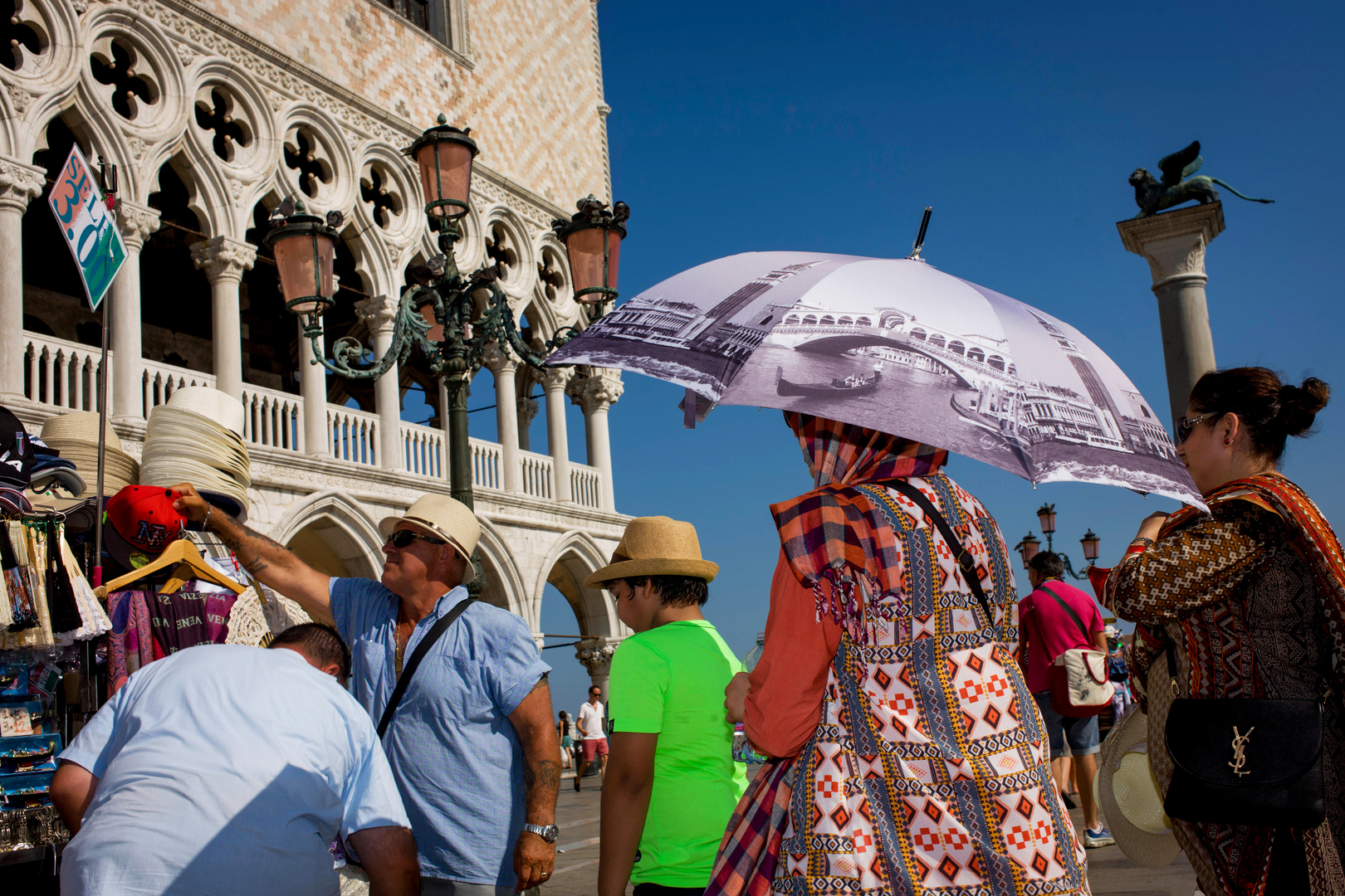 A woman with an umbrella featuring a bridge design.